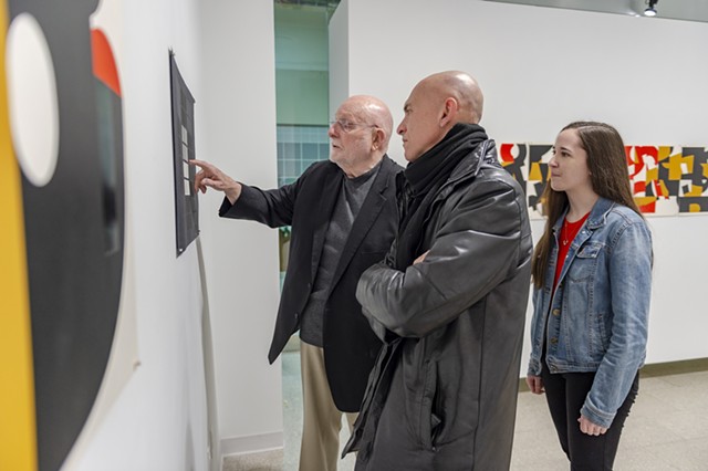 R. Roger Remington gives a tour of his exhibition "Formation" with Professor Josh Owen and design student Trista Finch.