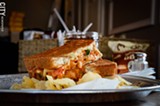 PHOTO BY MARK CHAMBERLIN - A chipotle chicken sandwich — Italian bread, muenster cheese, pulled chicken, tomatoes, fresh basil, and chipotle sauce — from Cheese Masters on Park Avenue.