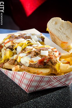 A Mac plate: mac salad and french fries, topped with 2 burger patties, diced onions, ketchup, mustard and meat hot sauce. - PHOTO BY MARK CHAMBERLIN