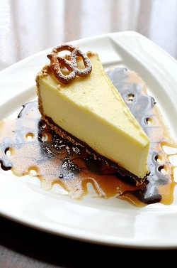 Cheesecake with a pretzel crust and caramel sauce from Tournedos Steakhouse. - PHOTO BY MATT DETURCK