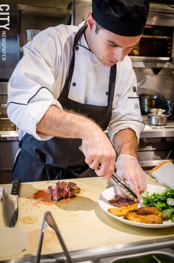 Chef Joel Valenti plating the Amore Steak. - PHOTO BY MARK CHAMBERLIN