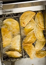 PHOTO BY MARK CHAMBERLIN - Fresh empanadas, seen here frying in the kitchen.