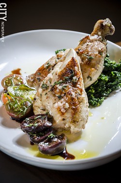 Half roasted chicken stuffed with foie gras and truffles and served with braised greens and tomatoes, from Avvino. - PHOTO BY MARK CHAMBERLIN