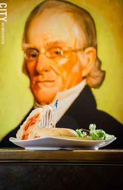 Nathaniel Rochester looks over a five cheese and tomato panini, served with a side salad. - PHOTO BY MARK CHAMBERLIN