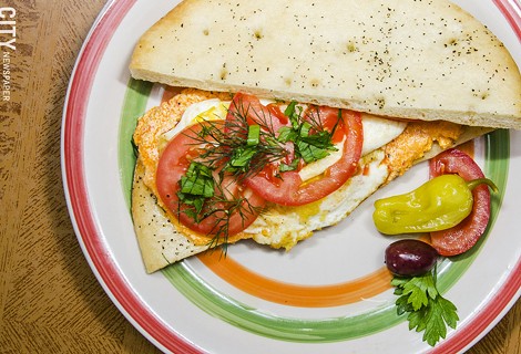 Rochester has an abundance of breakfast sandwich options, ranging form the standard to the more creative, like Voula's: Breakfast Sandwich with two fried eggs, kafteri, and fresh herbs on lagana flatbread. - PHOTO BY MARK CHAMBERLIN