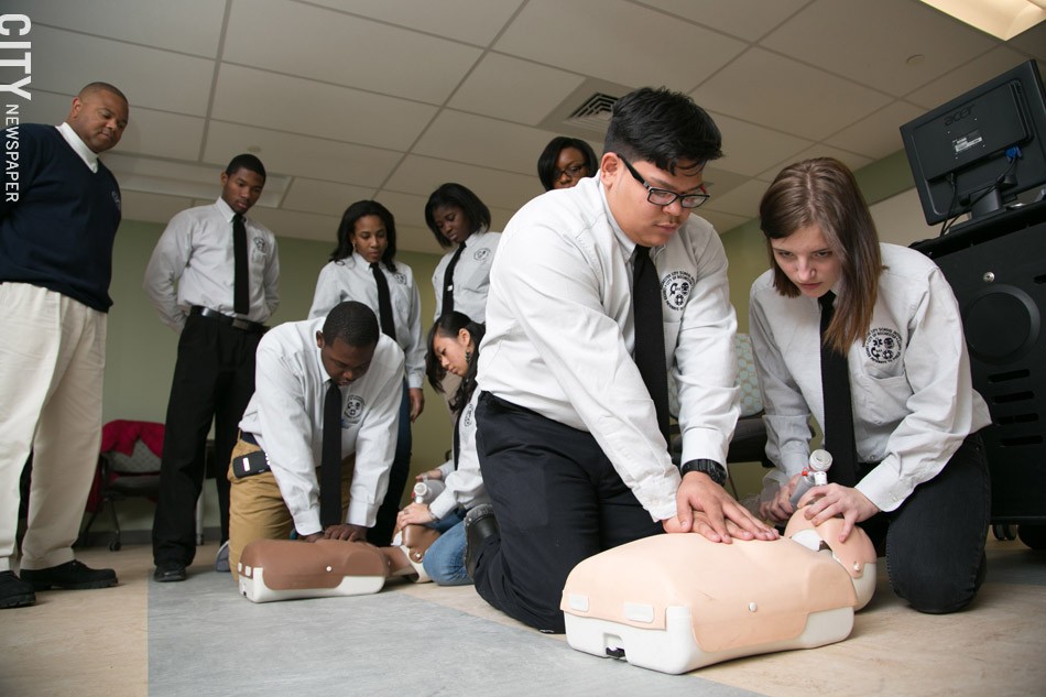 Students Teodoro Santiago and Melissa Calkins practice CPR during class. - PHOTO BY MIKE HANLON