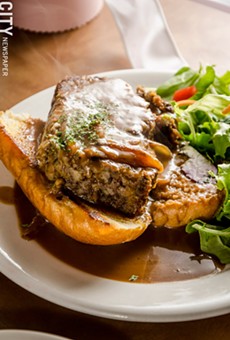 The open-faced meatloaf sandwich, which has a rice-based filler and is studded with fresh mozzarella and beef, with caramelized onion gravy with parsley on top.