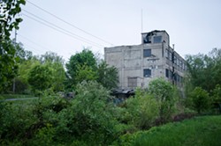 A vacant, dilapidated building at the end of Flint Street marks the Vacuum Oil site. - FILE PHOTO