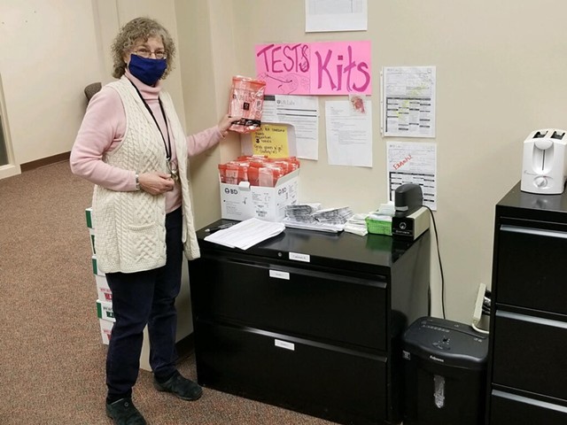 The Monroe County Health Department's isolation and quarantine group leader, Kathy Hiltunen, with coronavirus test kits at the department's offices. - PHOTO PROVIDED BY MONROE COUNTY HEALTH DEPARTMENT