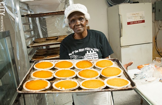 Alberta Jacque presents a tray of fresh pies at Sweet Potato Pie Factory & More. - FILE PHOTO