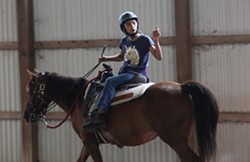 Toni Ayala, 12, of Rochester, has found a home away from home at the stables, saying she comes every day — even if it's just to feed the horses. - PHOTO CREDIT MAX SCHULTE / WXXI NEWS