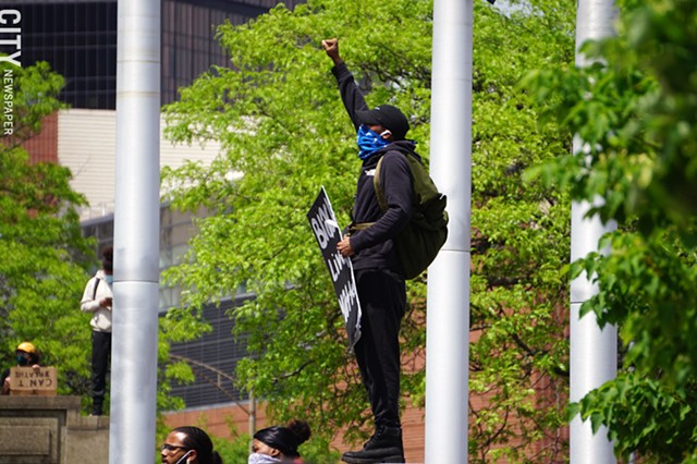 A man gives the Black Power salute of a raised fist at a protest in Rochester on May 30, 2020. - PHOTO BY GINO FANELLI