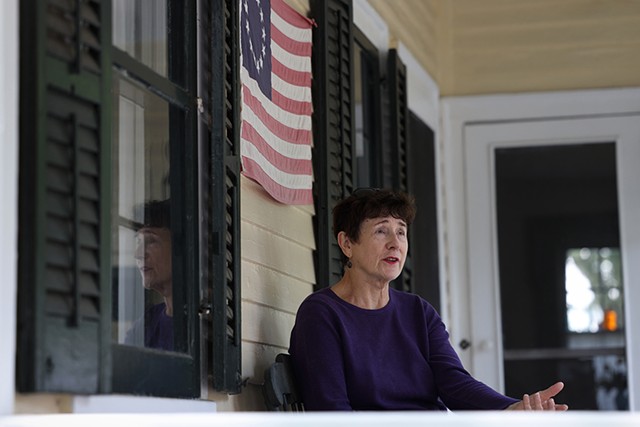 Lynn Barber on the porch of her historic home in Fairport. - PHOTO BY MAX SCHULTE