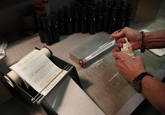 Just as in the olden days, all of Fee Brothers' bottles are labeled by hand. - PHOTO BY MAX SCHULTE