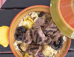Un-skewer the meat and veggies and set them over a bed of couscous and olives. - PHOTO BY JACOB WALSH