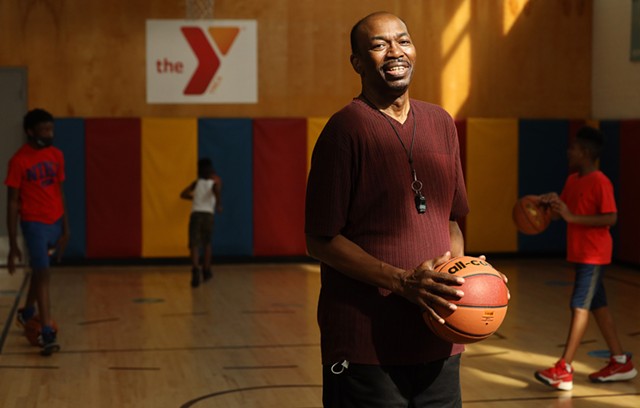 David Everett, one of the Lewis Street Committee leaders, teaches kids basketball at the YMCA Center for Equity. Everett grew up at the Lewis Street Settlement House and played basketball as a boy in the same YMCA. - PHOTO BY MAX SCHULTE