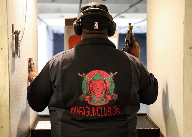 Paul Adell, a founder of the Rochester African American Firearms Association, sends a paper target down range before practice at The Firing Pin in Bergen. - PHOTO BY MAX SCHULTE