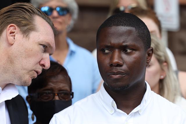 Firefighter Jerrod Jones, right, and his lawyer, Nate McMurray, during a news conference on the steps of City Hall on Aug. 11, 2022. Jones intends to sue the city for being made to attend a party at the East Avenue home of Dr. Nicholas Nicosia and his wife, Mary Znidarsic-Nicosia. - PHOTO BY MAX SCHULTE