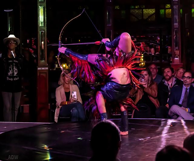 Gana Oyunchimeg uses a bow and arrow with only her feet during "Cirque du Fringe: Afterglow." - PHOTO BY AARON WINTERS