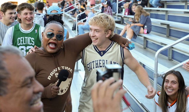 Karen Iglesia and Nick Holmquist, a lacrosse player at Sutherland High School in Pittsford and a leader of the "Sutherland Superfans," chat for a PrimeTime585 pre-game show. In the foreground, Gerard Iglesia works the camera. - PHOTO BY MAX SCHULTE