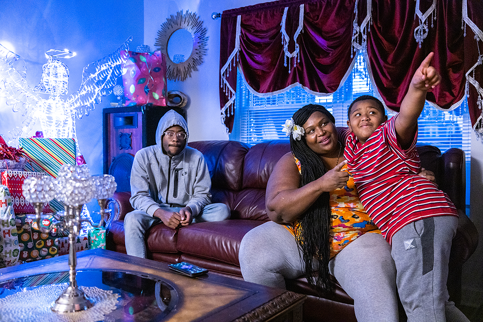 Sparkle, 44, in her home with sons Jakai, 17, and Christian, 7. - PHOTO BY MATT BURKHARTT