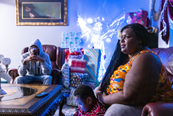 Sparkle, 44, in her home with sons Jakai, 17, and Christian, 7. - PHOTO BY MATT BURKHARTT