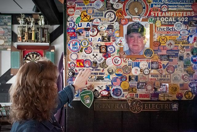 The wall next to Seamus's favorite bar stool is plastered with union stickers, a tribute to his affinity for the working person. - PHOTO BY JACOB WALSH