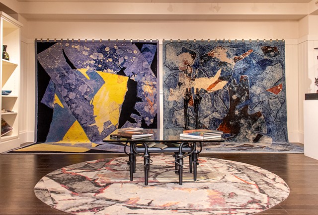 Three area rugs created from monoprints by albert Paley displayed in the showroom at Oriental Rug Mart in Eastview Mall. - PHOTO BY JACOB WALSH