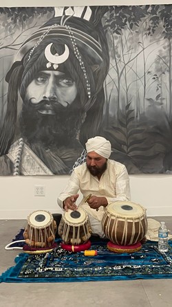 A performance of traditional music on opening night in front of Sunroop Kaur's painting, 'Nihang Singh.' - PHOTO PROVIDED