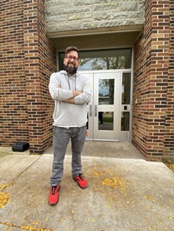Zachary Ennis, founder of Rochester Deaf Kitchen, stands outside the building that houses the deaf food pantry he first envisioned 12 years ago. - TOM WILLARD.