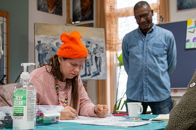 Artist Richmond Futch, Jr. (right) watches over Joanna Mingo as she takes part in the weekly free art sessions he holds at St. Joseph's House of Hospitality. - PHOTO BY JACOB WALSH