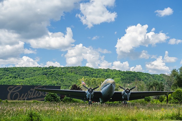 A Curtiss C-46 Commando, a vintage cargo plane from World War II, sits at the entrance to the Glenn H. Curtiss Museum in Hammondsport. - PHOTO BY ABBY QUATRO