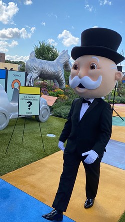 Mr. Monopoly, mascot for the Hasbro board game Monopoly, poses near mock-ups for proposed squares in the game's Rochester version, set for release in February 2025. - PATRICK HOSKEN