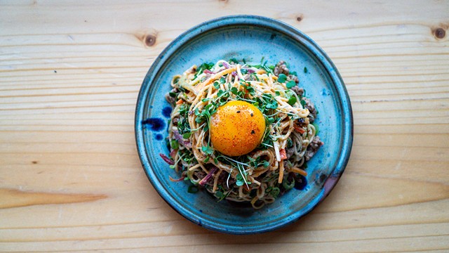 Spicy ramen salad: Soy-marinated pork, micro greens, sesame dressing, egg yolk. - PETE WAYNER.