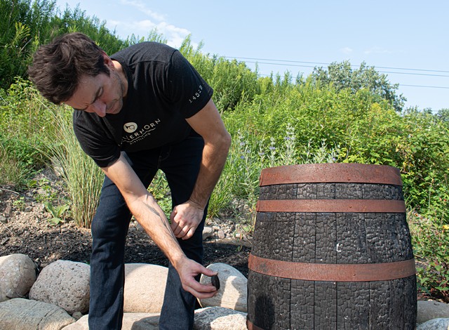 Karl Neubauer samples a barrel at Hollerhorn Distilling. - PHOTO BY JACOB WALSH.