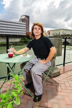 Orange Glory employee Sam Gilbert on the patio of the center city location on the Constellation Brands campus. - ABBY QUATRO.