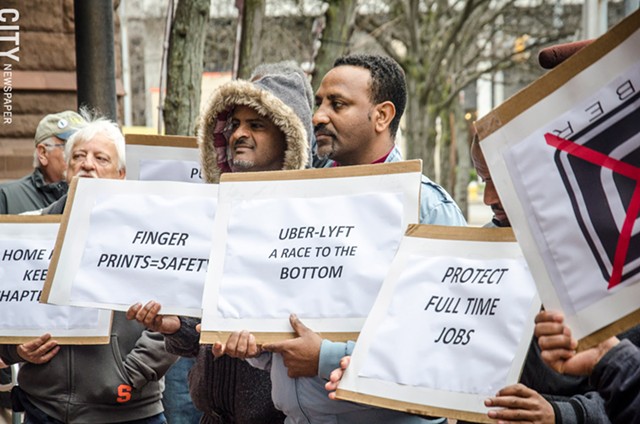 Local cab drivers rallied against Uber at City Hall last month. - PHOTO BY MARK CHAMBERLIN