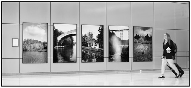 Installation view of Richard Margolis' photographs at the Greater Rochester International Airport. The images have been removed and advertisements have been installed in their place. - PHOTOGRAPH COURTESY OF RICHARD MARGOLIS