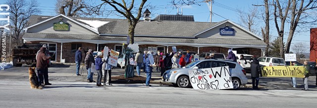 Demonstrators have gathered outside of House Representative Chris Collins's Geneseo office every Tuesday for the past few weeks in an attempt to get him to hold a town hall meeting. - PHOTO BY JEREMY MOULE