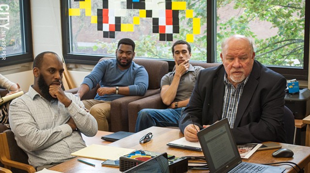 John Klofas (right), director of the Center for Public Safety Initiatives at RIT, with (from left) Irshad Altheimer, the center's deputy director, and research assistants Chaquan Smith and Aaron Baxter, at the center's weekly research meeting. - PHOTO BY RYAN WILLIAMSON
