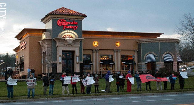 Activists and workers staged a rally near the Cheesecake Factory in Pittsford Plaza yesterday to call attention to worker scheduling regulations under consideration by the New York State Department of Labor. - PHOTO BY RENEE HEININGER