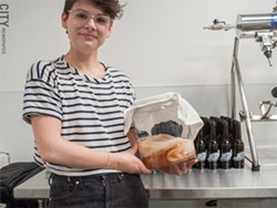Katboocha owner Kat Schwarz cradles one of her scobys, which are the bacteria and yeast cultures used to create kombucha from tea. - PHOTO BY JACOB WALSH