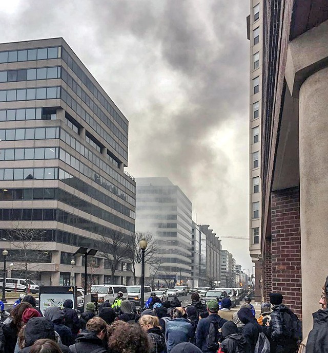 Smoke from a burning limousine as seen hours after mass arrests on Inauguration Day. - PHOTO BY AARON CANTÚ