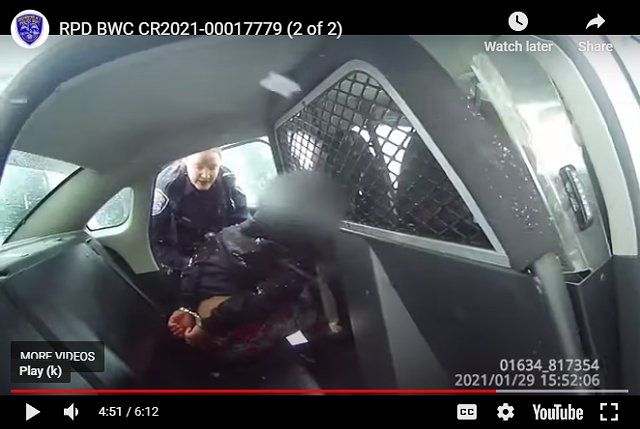 A screen grab from a Rochester Police Department body-worn camera that captured a female officer pepper-spraying a 9-year-old handcuffed girl.