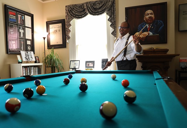Van White plays pool on the table that Martin Luther King Jr. played on while a student at Crozer Theological Seminary. White had the pool table restored and placed it in a room in his law office dedicate to King's  legacy.