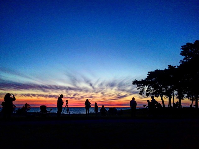 Skywatchers view eclipse from Hamlin Beach.