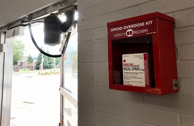An emergency Narcan box is positioned next to the front door of Boost Mobile at 570 W. Main St.