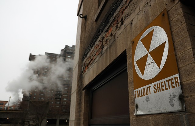A fallout shelter sign clings to the facade of a former State University at Brockport building on Bragdon Place in downtown Rochester.