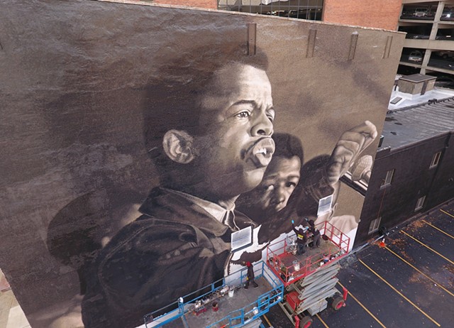 Rochester native Ephraim Gebre, along with fellow artists Darius Dennis, Dan Harrington, and Jared Diaz, bring John Lewis to life in a mural inspired by an image taken by civil rights-era photographer Danny Lyon. The mural, titled "I am Speaking," went up on State Street in downtown Rochester in 2020.