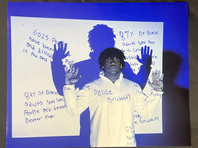 Chazmir Law, a 17-year-old in the Flower City Arts Center's Expanding the Field program, poses for his self-portrait, "Police Brutality in America."